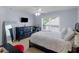 Cozy bedroom featuring a queen bed, dresser, and a window with natural light at 1258 Mcallistar Dr, Locust Grove, GA 30248