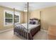 Cozy bedroom with four-poster bed, ceiling fan, and large window at 1258 Mcallistar Dr, Locust Grove, GA 30248