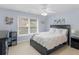 Bedroom with a bed facing a large window, and a dark colored dresser with shelving at 1258 Mcallistar Dr, Locust Grove, GA 30248