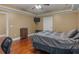 Bedroom with hardwood floors, ceiling fan, and modern trim package at 1258 Mcallistar Dr, Locust Grove, GA 30248