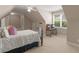 A neutral room with a bed, small desk and a dormer window at 1258 Mcallistar Dr, Locust Grove, GA 30248