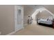 A neutral bedroom in a converted attic space featuring a writing desk and dormer ceilings at 1258 Mcallistar Dr, Locust Grove, GA 30248