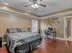 Bedroom with hardwood floors, ceiling fan, desk and Georgia Tech logo on wall at 1258 Mcallistar Dr, Locust Grove, GA 30248