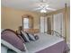Bedroom with a gold metal canopy bed, a ceiling fan, and a wooden dresser with mirror on top at 1258 Mcallistar Dr, Locust Grove, GA 30248