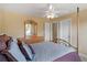 Well-lit bedroom with four-poster bed and matching dresser with mirror at 1258 Mcallistar Dr, Locust Grove, GA 30248