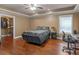 Bedroom with hardwood floors, ceiling fan, closet and natural light from window at 1258 Mcallistar Dr, Locust Grove, GA 30248