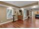 Open concept bonus room with hardwood floors, modern trim package, TV and access to other areas at 1258 Mcallistar Dr, Locust Grove, GA 30248