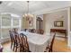 Traditional dining room with hardwood floors, large windows, and a classic chandelier at 1258 Mcallistar Dr, Locust Grove, GA 30248