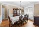 Formal dining room with a chandelier, hardwood floors, large windows, and beautiful trim work at 1258 Mcallistar Dr, Locust Grove, GA 30248