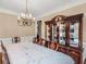 Bright dining room with a crystal chandelier, hardwood flooring, and a china cabinet at 1258 Mcallistar Dr, Locust Grove, GA 30248