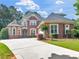 Beautiful two-story brick home with a well-manicured lawn and a long driveway at 1258 Mcallistar Dr, Locust Grove, GA 30248
