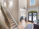 Grand foyer with staircase and double doors to the dining room at 1258 Mcallistar Dr, Locust Grove, GA 30248