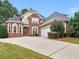 Beautiful brick two-story home with mature landscaping and an extended driveway at 1258 Mcallistar Dr, Locust Grove, GA 30248