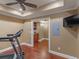 Home gym featuring hardwood floors and tray ceilings at 1258 Mcallistar Dr, Locust Grove, GA 30248