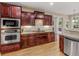 Well-equipped kitchen with dark wood cabinets, granite countertops, and stainless steel appliances at 1258 Mcallistar Dr, Locust Grove, GA 30248