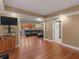 Open floor plan with hardwood flooring, recessed lights, leather sofa, and nearby kitchen area at 1258 Mcallistar Dr, Locust Grove, GA 30248