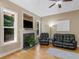 Cozy living room with a fireplace, large windows, and comfortable seating at 1258 Mcallistar Dr, Locust Grove, GA 30248