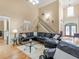 Bright living room featuring a staircase, large windows, and comfortable seating at 1258 Mcallistar Dr, Locust Grove, GA 30248