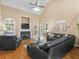 Cozy living room with a fireplace, vaulted ceilings, and ample natural light from large windows at 1258 Mcallistar Dr, Locust Grove, GA 30248