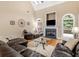 Inviting living room showcasing a fireplace, arched windows, and comfortable leather furniture at 1258 Mcallistar Dr, Locust Grove, GA 30248