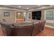 Cozy living room featuring a large brown leather sectional sofa and hardwood flooring at 1258 Mcallistar Dr, Locust Grove, GA 30248