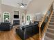 Inviting living room featuring a fireplace, staircase, hardwood floors and ample natural light at 1258 Mcallistar Dr, Locust Grove, GA 30248