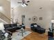 Open living space featuring a staircase, hardwood floors, and comfortable leather seating at 1258 Mcallistar Dr, Locust Grove, GA 30248