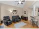 Inviting living room features vaulted ceilings, ceiling fan, hardwood flooring, desk space, and comfortable seating at 1258 Mcallistar Dr, Locust Grove, GA 30248