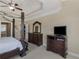 Well-appointed main bedroom with a four-poster bed and ample space for dressers and seating at 1258 Mcallistar Dr, Locust Grove, GA 30248