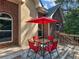 Outdoor patio area featuring a table, chairs, and a red umbrella, great for entertaining at 1258 Mcallistar Dr, Locust Grove, GA 30248