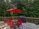 Outdoor patio area featuring a table, chairs, and a Weber grill, great for entertaining at 1258 Mcallistar Dr, Locust Grove, GA 30248