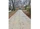 Long concrete driveway leading up to the house with space for multiple vehicles at 2480 Glenbonnie Dr, Dunwoody, GA 30360