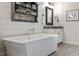 Bright bathroom features a free-standing soaking tub with stylish fixtures and decorative shelving at 364 Concord St, Alpharetta, GA 30009