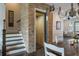 Unique home elevator with brick surround, open to the dining and staircase at 364 Concord St, Alpharetta, GA 30009