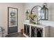Stylish entryway with decorative mirror, wall decor and wood-look cabinets at 364 Concord St, Alpharetta, GA 30009