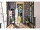 Inviting front door with decorative wreath, potted plants, and brick surround detail at 364 Concord St, Alpharetta, GA 30009