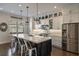 Modern kitchen with stainless appliances, white cabinets, and island with barstool seating at 364 Concord St, Alpharetta, GA 30009