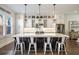 Spacious kitchen with an island, white cabinets, stainless steel appliances, and stylish pendant lighting at 364 Concord St, Alpharetta, GA 30009