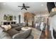 Open-concept living room with hardwood floors, brick accent wall and a fireplace at 364 Concord St, Alpharetta, GA 30009