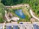 Aerial view of a pond with fountain and walking paths surrounded by lush greenery and trees at 364 Concord St, Alpharetta, GA 30009