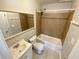 Bathroom with a vanity, commode, and a shower/tub combo with tile surround at 709 Pine Tree Trl # 10A, Atlanta, GA 30349