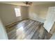 Clean and modern bedroom with wood-look flooring and a ceiling fan at 709 Pine Tree Trl # 10A, Atlanta, GA 30349