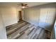 Spacious bedroom features neutral walls and modern plank flooring plus ceiling fan at 709 Pine Tree Trl # 10A, Atlanta, GA 30349
