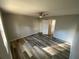 Bright bedroom with wood-look flooring, a ceiling fan, and a large window at 709 Pine Tree Trl # 10A, Atlanta, GA 30349