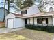 Charming two-story home featuring a covered front porch, garage, and well-maintained landscaping at 709 Pine Tree Trl # 10A, Atlanta, GA 30349