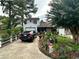 Charming home featuring mature landscaping, a long driveway, and an attached one-car garage at 709 Pine Tree Trl # 10A, Atlanta, GA 30349