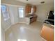 Bright kitchen featuring tile flooring, a window above the sink, and stainless steel appliances at 709 Pine Tree Trl # 10A, Atlanta, GA 30349