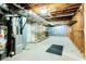 Unfinished basement featuring utilities, open ceiling, and some shelving for storage or future customization at 1905 Eagle Valley Ct, Lawrenceville, GA 30043