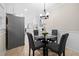 Eat-in kitchen with a modern chandelier and a glass-top dining table at 2151 Zelda Ne Dr, Atlanta, GA 30345
