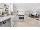 Bright kitchen featuring stainless steel appliances, a farmhouse sink, and granite countertops at 2151 Zelda Ne Dr, Atlanta, GA 30345